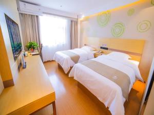 a hotel room with two beds and a window at GreenTree Inn Beijing Shunyi District Fuqian West Street Shimen Subway Station Express Hotel in Beijing