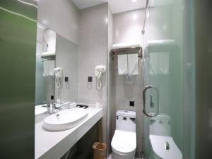 a bathroom with a toilet and a sink at GreenTree Inn Dezhou Bus Station Train Station Express Hotel in Dezhou