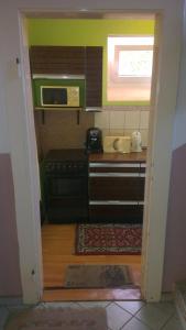 a small kitchen with a stove and a microwave at Pension Lada in Karlovy Vary
