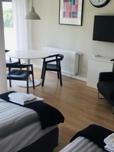 a room with a table and chairs and a table and a table at Golf Apartament 10 in Wejherowo
