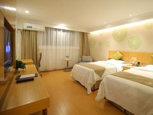 a hotel room with two beds and a flat screen tv at GreenTree Inn Huaibei Suixi county Sandikou Business Hotel in Huaibei