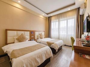 Tempat tidur dalam kamar di Shell Kaifeng City Lancao County Women and Children Hospital Hotel