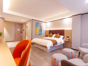 a hotel room with a bed and chairs in it at Gya Yangzhou Slender West Lake Hotel in Yangzhou