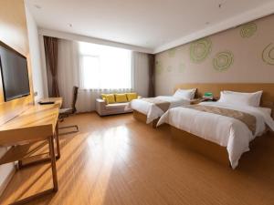 a hotel room with two beds and a flat screen tv at GreenTree Inn Baoding City Cangzhou Guanyun West Road Business Hotel in Zhuozhou +18 photos