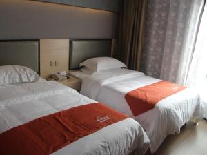 Postelja oz. postelje v sobi nastanitve Shell Shanghai Chedun Yingshi City Yingshi Road Hotel