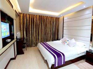 Letto o letti in una camera di GreenTree Alliance Jinhua Dongyang East Bus Station Dongyong Road Hotel