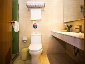 a bathroom with a toilet and a sink at GreenTree Inn Jiangsu Yancheng Tinghu Wengang road Frontier defense bureau Business Hotel in Yancheng