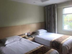 Krevet ili kreveti u jedinici u okviru objekta GreenTree Inn Jiangsu Nantong Haimen Bus Statian Shell Hotel