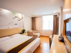 a hotel room with a bed and a television at GreenTree Inn Anhui Hefei Wuhu Road Wanda Plaza Express Hotel in Hefei