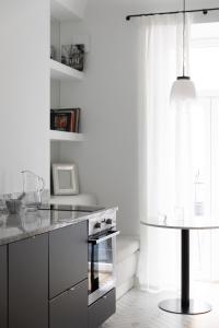 a kitchen with a stove and a counter top at MIRO Rooms - French chic, free private parking in Rīga