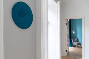 Pokój z niebieskim kołem na ścianie w obiekcie MIRO Rooms French - quiet chic, free private parking w Rydze