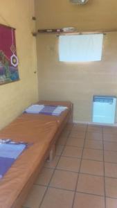 a small room with two wooden beds in it at Cabaña de montaña in Cosquín