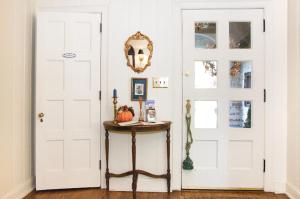 Habitación con puerta blanca y mesa con espejo. en Longacre of Appomattox, en Appomattox