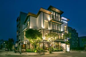 a tall building with lights on it at night at Sense Villa by Enspired Vietnam in Da Nang