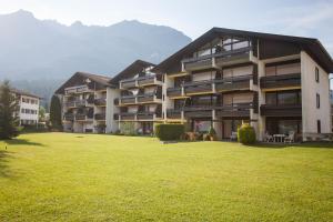 a large apartment building with a large grass field at Alpenglück Whg. 20 in Garmisch-Partenkirchen