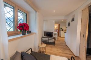 a living room with a couch and a television at Florin Ferien in Klosters