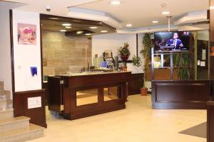 a lobby with a counter and a tv in a room at Insitu Eurotel Andorra in Andorra la Vella