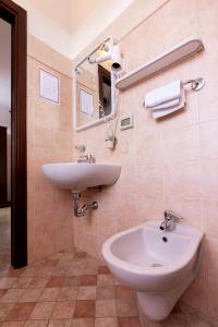 a bathroom with a sink and a mirror at Osteria Belvedere in San Leo