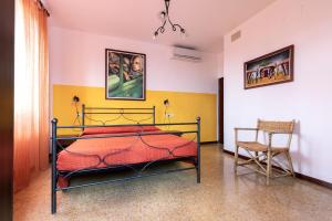 a bedroom with a bed and a chair at Osteria Belvedere in San Leo