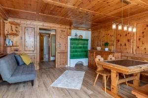 a living room with a table and a couch at Florin Ferien in Klosters