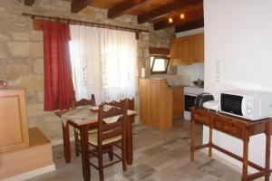 a kitchen with a table and a microwave on a table at Villa Eleva in Argyroupolis
