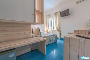 una camera d'albergo con panchina e letto di Hotel Eunymos a Panarea