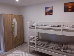 a room with two bunk beds and a closet at Amera-Ferienwohnung in Lübeck