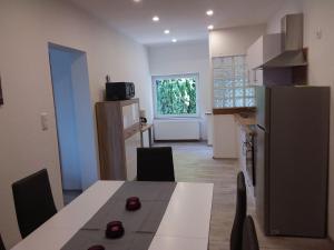 a kitchen and dining room with a table and a refrigerator at Amera-Ferienwohnung in Lübeck