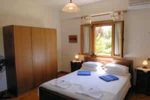 a bedroom with a bed with blue towels on it at Crete Family Villas in Pentamodi +64 photos