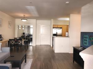 a living room and kitchen with a couch and a table at "Resort Style amenities walk to UCLA" w Pool & Parking B2 in Los Angeles