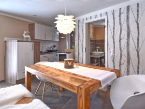 a kitchen with a wooden table in a room at Apartment with private terrace in Friedrichshöhe