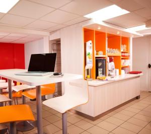 a kitchen with a desk with a laptop on a counter at Premiere Classe Villepinte Centre - Parc des Expositions in Villepinte