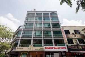 a tall building with a sign in front of it at Subang Valley in Subang Jaya