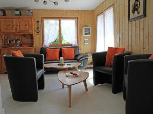 a living room with couches and a table at Chalet in Saclentse Basse Nendaz near Ski Area in Nendaz