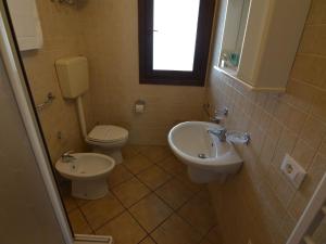 un baño con inodoro y lavabo en Resort Apartment with Pool, en Lido di Spina 33 fotos más