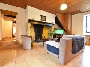 a living room with a couch and a fireplace at Scenic Home in Berbiguières in Saint-Germain-de-Belvès