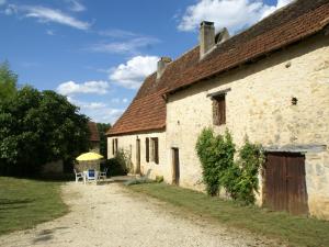 an old stone building with a table and chairs at Scenic Home in Berbiguières in Saint-Germain-de-Belvès