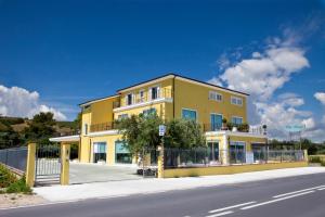 a yellow building on the side of a street at Villa Imago in Roseto degli Abruzzi