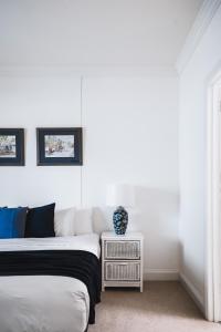 a bedroom with two beds and a side table at Barkers Run Terrace in Castlemaine