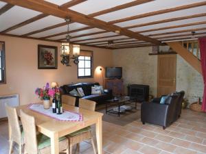 a living room with a table and a couch at Detached holiday home in the Normandy countryside in Saint-Germain-du-Pert