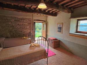 ApecchioにあるFarmhouse with pool in the hills beautiful views in the truffle areaのベッドルーム1室(ベッド2台、窓付)