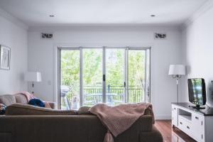 a living room with a couch and a television at Barkers Run Terrace in Castlemaine