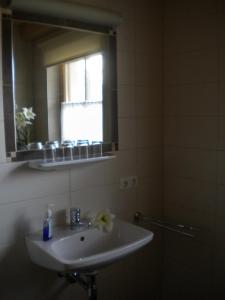 a bathroom with a sink and a mirror at Haus Helene in Rauris +17 photos
