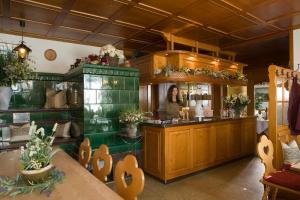 a woman standing behind the counter of a restaurant at Landgasthaus Engel - Naturparkwirt in Höchenschwand