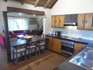 a kitchen with a table and a stove top oven at Luxury holidayhome in gated estate near Kruger Park and Golf in Phalaborwa