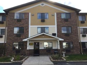 an apartment building with the front door open at Super 8 by Wyndham Canton/Livonia Area in Canton