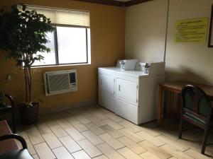 a room with a refrigerator and a window at Super 8 by Wyndham Canton/Livonia Area in Canton