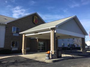 a dunkin donuts building with a donut shop at Super 8 by Wyndham Adrian in Adrian