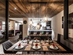 a dining room and kitchen with a table and chairs at Graceful Chalet in Gaschurn with Sauna in Gaschurn