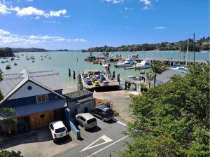 a marina with boats and cars parked in a parking lot at Paihia Star Motel in Paihia